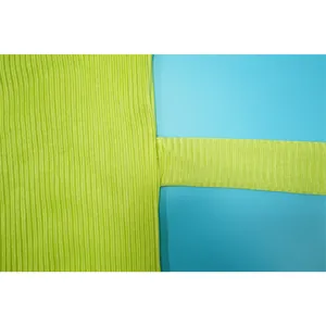 Close-up detail of pleated lime green fabric showing texture and strap stitching