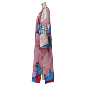 Side view of a loose floral print long-sleeve kaftan dress featuring a satin texture
