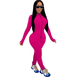 Full-body shot of a vibrant hot pink long-sleeve tight jumpsuit for a sexy sporty look