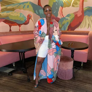 Fashionable long-sleeved floral print kimono windbreaker in a lifestyle cafe setting
