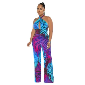 Sexueller rückenfreier Neckholder-Jumpsuit mit lebhaftem tropischem Palmenblatt-Print.