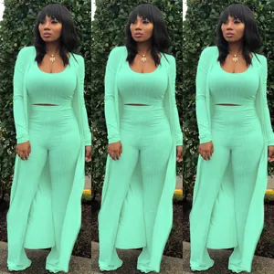 Three-piece mint green ribbed knit set with crop top, high-waisted pants, and cardigan