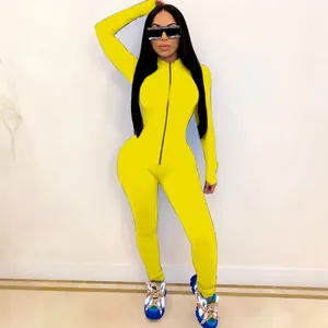 Close-up of a form-fitting yellow one-piece bodysuit with front zipper detail.