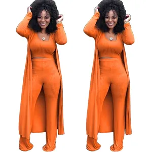 Detail view of orange ribbed knit 3-piece set with crop top, pants, and cardigan
