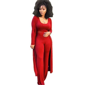 Detail of the red 3-piece ribbed knit set featuring a crop top, pants, and cardigan.