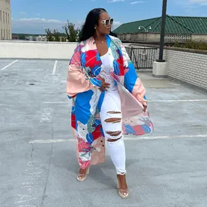 Full-length view of a colorful floral print long kimono cardigan on a model outdoors.