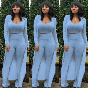 Three-piece light blue ribbed knit set featuring cardigan, crop top and wide-leg pants.