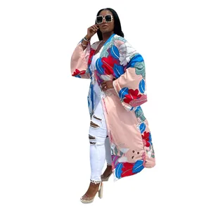 Detailed view of floral print kimono windbreaker on model with white ripped jeans.
