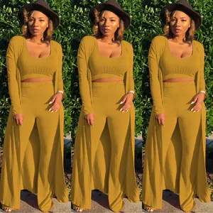 Full view of a three-piece mustard yellow ribbed knit set with top and flared pants.