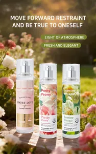 Detailed view of three 150ml floral fragrance sprays in a sunlit garden setting.