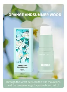 Close-up detail of FORMBO solid perfume fragrance balm stick and floral packaging box
