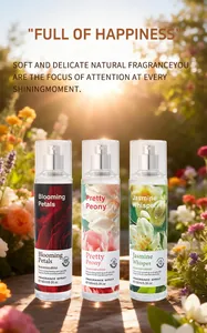Detailed view of three 150ml floral fragrance sprays in a sunlit garden