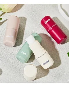 Detail showing multi-colored FORMBO solid perfume balms on a textured stone surface