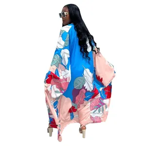 Back view of a loose long-sleeved kimono cardigan with colorful leaf print on white background
