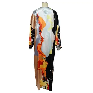 Back view of a long satin kaftan robe featuring an abstract orange and black print