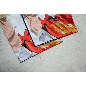 Detail of vibrant floral print on soft satin fabric for casual kimono duster coat