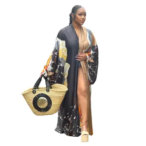 Detail view of long oversized kimono robe with floral print and black tan patchwork