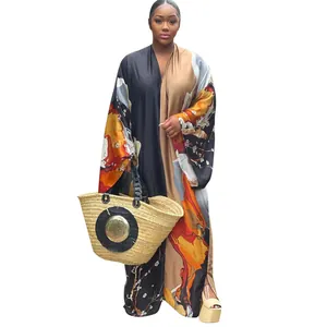 Detailed view of women's long-sleeved autumn kimono dress with vibrant abstract print