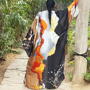 Back view of a long loose kimono windbreaker with vibrant abstract autumn prints