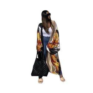 Full body view of a long oversized kimono cardigan with vibrant autumn floral patterns