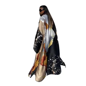 Detail view of a loose-fitting printed kimono robe with elegant floral patterns.
