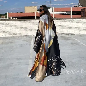Detailed side view of elegant long satin kimono windbreaker with floral print design