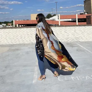 Back view of a loose casual autumn kimono cardigan with abstract colorful print outdoors.