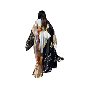 Detailed back view of long-sleeved satin kimono duster with artistic abstract print