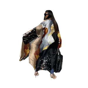Back view of a long elegant printed casual kimono cardigan featuring wide flowy sleeves