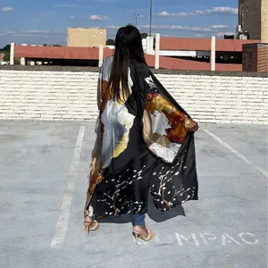Back view of a loose long-sleeved printed kimono robe with abstract art and floral patterns.