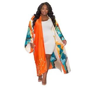 Plus size women's long kimono with vibrant abstract landscape print and wide sleeves.