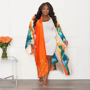 Full body view of long loose kimono cardigan featuring bold abstract floral prints