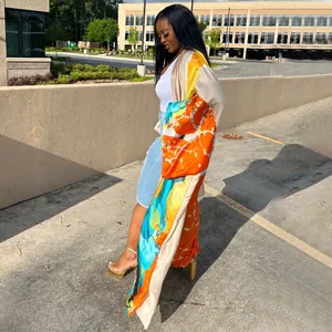 Stylish long-sleeved kimono duster coat with vibrant orange and teal floral prints.