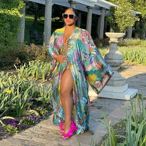Full-length view of a vibrant floral print kimono robe styled in a sunny garden setting