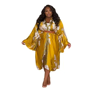 Full-length mustard yellow floral print kimono duster wrap with a stylish brown belt.