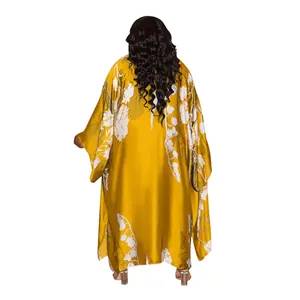 Detailed back view of a long floral print kimono robe in mustard yellow satin fabric