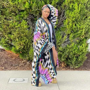 Full length view of a vibrant geometric print long kimono duster in a garden