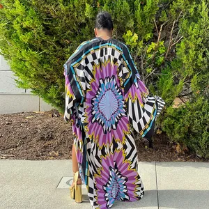 Back view of a long-sleeved loose kimono cardigan with vibrant colorful geometric floral print