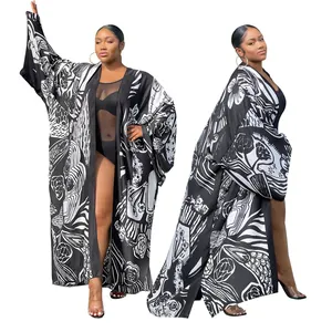 Full-body view of a long-sleeved kimono duster with black and white abstract print