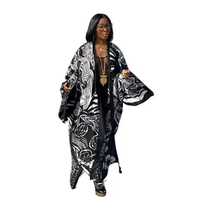 Detail shot of a long kimono windbreaker with artistic black and white floral prints
