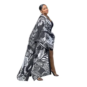 Full-length side view of a women's black and white floral printed loose casual kimono cardigan