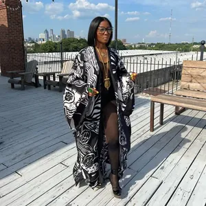 Full-length oversized women's kimono featuring bold black and white abstract floral print