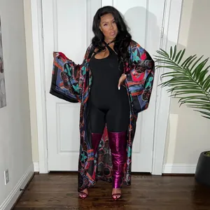 Full-length view of a woman in a colorful printed long sleeve kimono duster coat