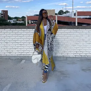 Outdoor street style shot of a woman wearing a printed loose casual kimono windbreaker