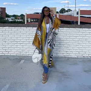Zebra and yellow print long kimono cardigan shown on a model in an urban outdoor setting