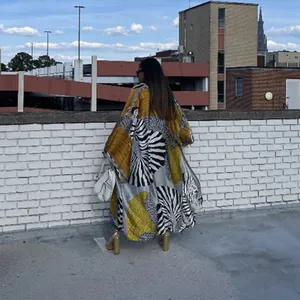 Back view of an oversized long kimono duster coat with yellow and zebra print patterns.