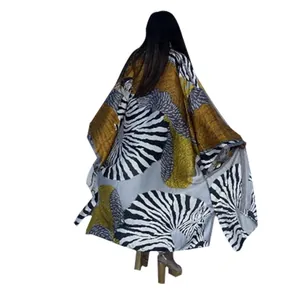 Back view of bohemian duster coat featuring bold zebra and ochre textured print patterns