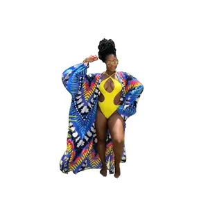 Detailed view of women's colorful printed bohemian kimono cover-up and yellow swimsuit set