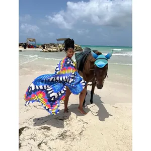 Vibrant multicolored printed bohemian kimono cardigan worn by a model on a tropical beach