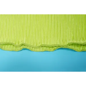 Macro view of lime green ribbed fabric texture showing the delicate wavy lettuce hem.